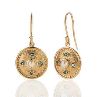 Gold earrings with pearl and topaz accents on a white background