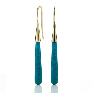 Gold and turquoise earrings on a white background
