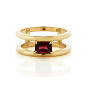 Ladies ring with a single rectangular ruby, set in four claws, and suspended between two bands of polished 18ct gold.