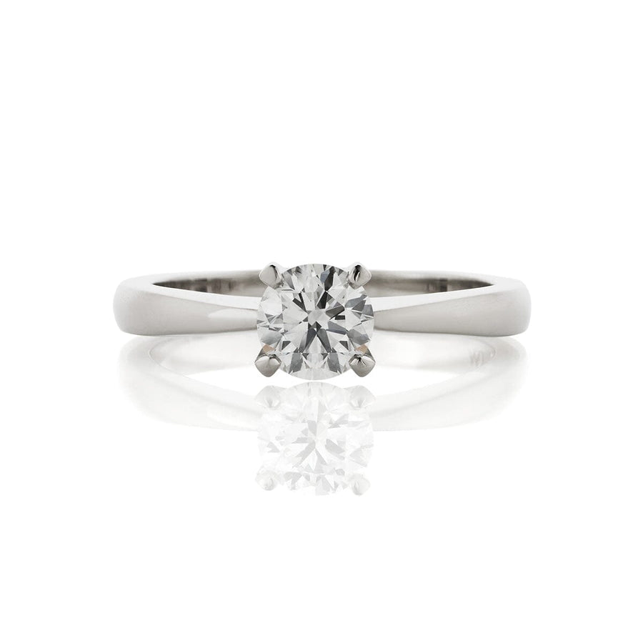 Four claw solitaire ring with a tapering band, made in platinum, with a 0.65ct round centre diamond. Top view.