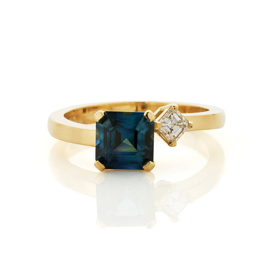 Ladies ring with central octagonal teal sapphire, flanked with a single off-set asscher cut diamond in 18ct gold